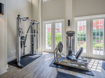 Premium fitness center with leg press and cable machines at Evergreens at Mahan apartments for rent